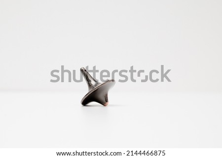 Totem spinning top spinning, wobbling and stopping. Inception's spinning top. Royalty-Free Stock Photo #2144466875