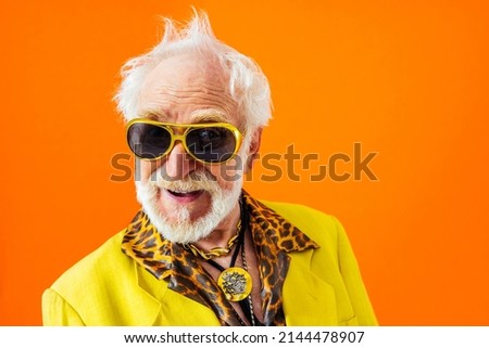 Cool senior man with fashionable clothing style portrait on colored background - Funny old male pensioner with eccentric style having fun Royalty-Free Stock Photo #2144478907