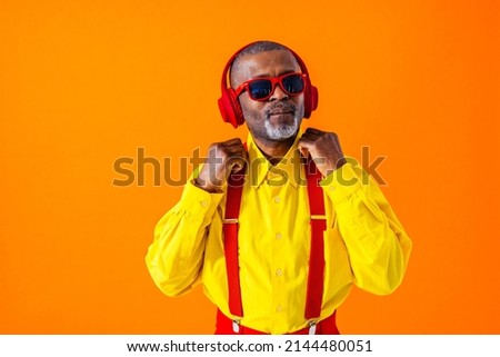 Cool senior man with fashionable clothing style portrait on colored background - Funny old male pensioner with eccentric style having fun Royalty-Free Stock Photo #2144480051