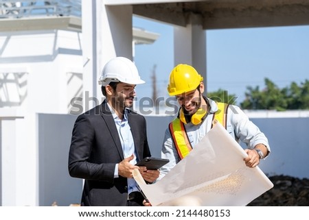 Engineer and businessman planning new residential subdivision home building in construction site. Royalty-Free Stock Photo #2144480153