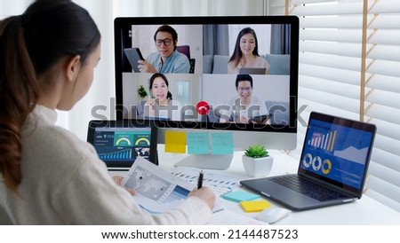 Happy smile asia young woman learn mba college class on wifi webcam video call in desktop pc screen with cowork friend workforce group talk in sale report. Smart job work at home for staff workspace. Royalty-Free Stock Photo #2144487523