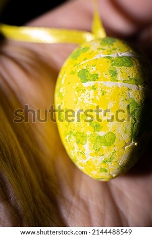 Mottled decorative eggs in a woman's hand.