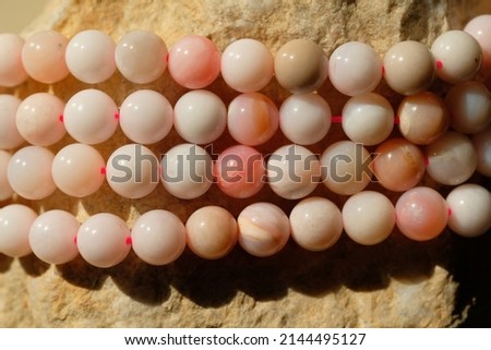 Round beads of natural pink opal.