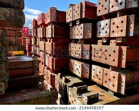 Red steel beams in outdoor storage. High quality photo