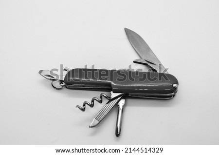 Isolated black and white switzerland knife, multi tool opened swiss army knife with wine opener in white background