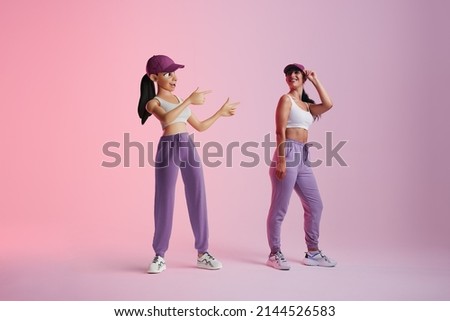 Cheerful young woman smiling at her metaverse avatar in a studio. Happy young woman standing next to the 3D simulation of herself. Sporty young woman exploring virtual reality. Royalty-Free Stock Photo #2144526583