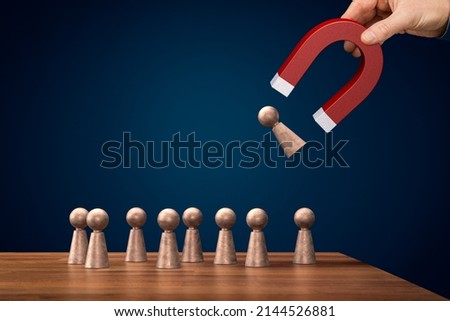 Magnet for your customers, clients or human resources. Marketing and management concepts. Hand of businessman with magnet attract figurine of person. Royalty-Free Stock Photo #2144526881