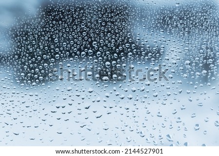 Raindrops on glass. Blue background