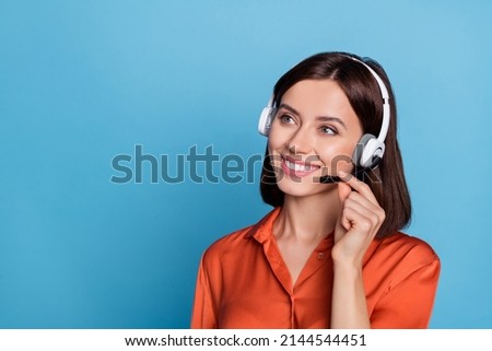 Profile side photo of young cheerful girl listen agent earphones look empty space isolated over blue color background Royalty-Free Stock Photo #2144544451