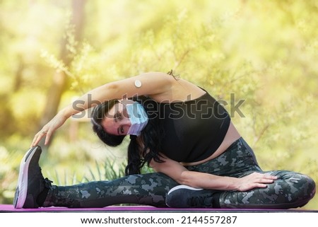 Adult woman with glucose sensor device stretching Royalty-Free Stock Photo #2144557287