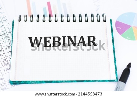 Notebook with text webinar on the table, business concept, education