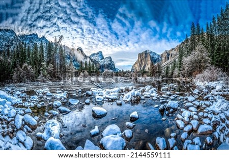 Snow on the rocks of a mountain river. Mountain forest river water in snow. Snowy mountain forest river valley. River stones in snow Royalty-Free Stock Photo #2144559111