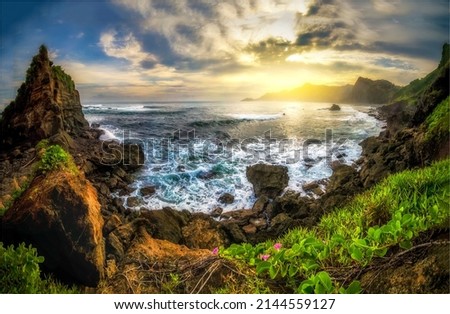 Sunrise on the horizon in a sea bay in the mountains. Beautiful coastline panorama at dawn. Sunrise sea coastal landscape. Mountain sea coast at dawn Royalty-Free Stock Photo #2144559127