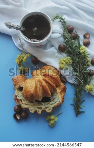 Croissants and morning coffee on a light blue background