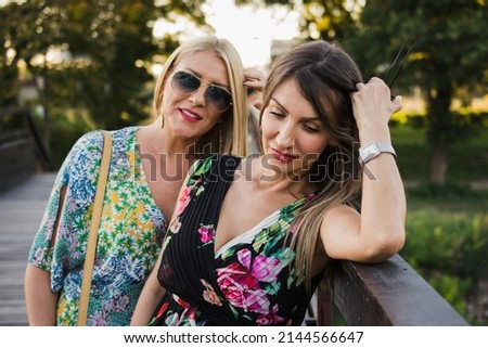 Two adult woman friends in park