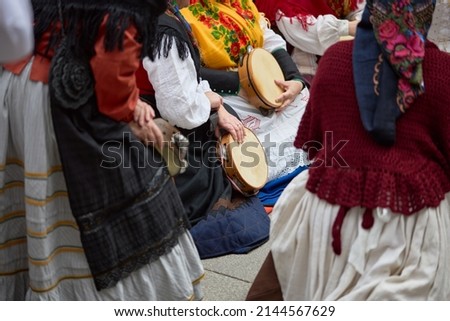 Women in period costumes playing tambourines at a popular festival in the city of Vigo, Galicia, Spain. Royalty-Free Stock Photo #2144567629