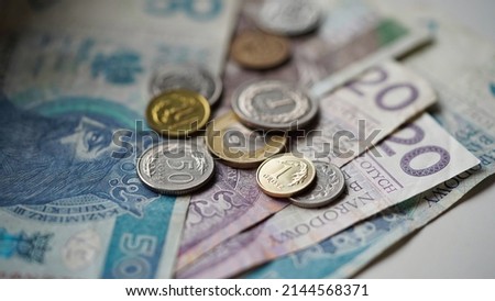 Close-up of zloty banknotes and coins on a white background, Polish currency. The concept of currency exchange in another country. Selective focus Royalty-Free Stock Photo #2144568371