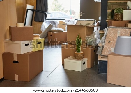 Background image of hallway in new home filled with cardboard boxes, family moving and relocation concept, copy space Royalty-Free Stock Photo #2144568503