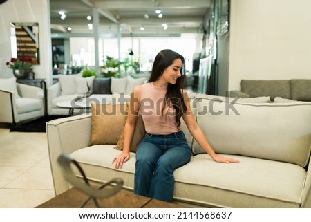New furniture for my home. Happy customer smiling while shopping for furniture for her living room Royalty-Free Stock Photo #2144568637