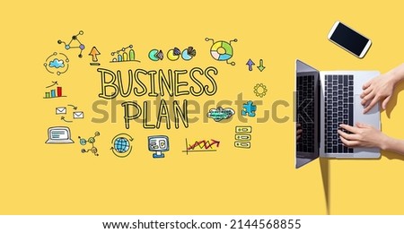 Business plan with person working with a laptop