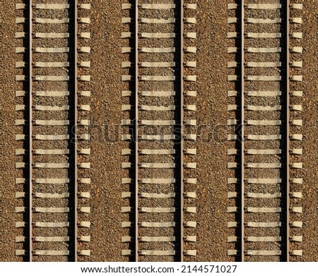 Seamless railroad Pattern, backdrop with space for text. Top view. Shiny iron rails and concrete sleepers, coupled with powerful bolts on stony ground, fortified rubble overgrown Royalty-Free Stock Photo #2144571027