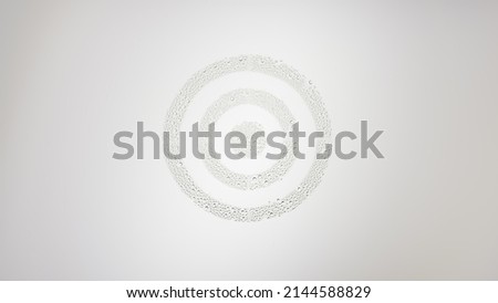 Sign target printed on the wet glass on grey background | skin care concept