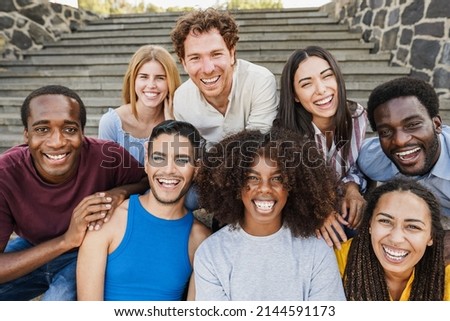 Young diverse people having fun outdoor laughing together - Focus on center african girl face Royalty-Free Stock Photo #2144591173