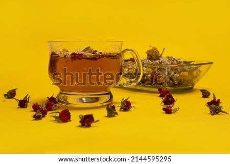 
Herbal and flower tea on a yellow background