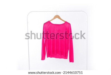 Pink sweatshirt closeup on hanger -white background