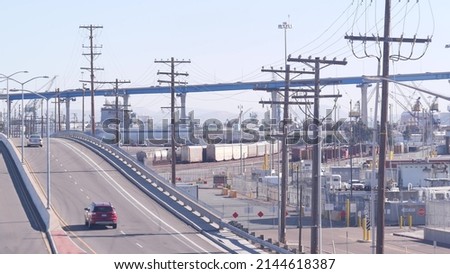 Industrial area, manufacturing or production district in San Diego, California USA. Coronado bridge and cars traffic. Fabrication and transportation infrastructure. Power lines or wires.