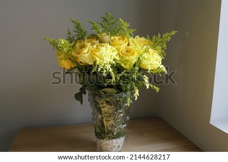 a yellow rose flower with coffe