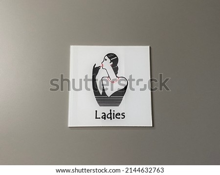 Singapore - APR 11,2022: Toilet sign for ladies. Restroom sign on a door with a grey colour