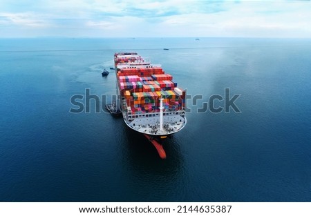 Arial view by drone camera transportation logistics and container dock cargo yard with working crane bridge in shipyard with transport logistic import export with blue sky background. Royalty-Free Stock Photo #2144635387