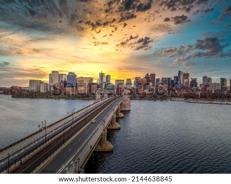 Aerial view of Boston downtown with the Longfellow bridge spanning over the Charles river, stunning dramatic colorful sunset sky