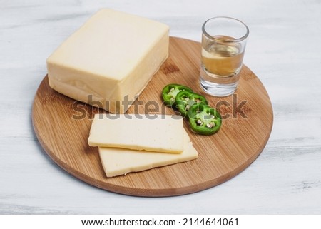 Mexican Chihuahua cheese or mennonite cheese and tequila or mezcal shot from Mexico Latin America