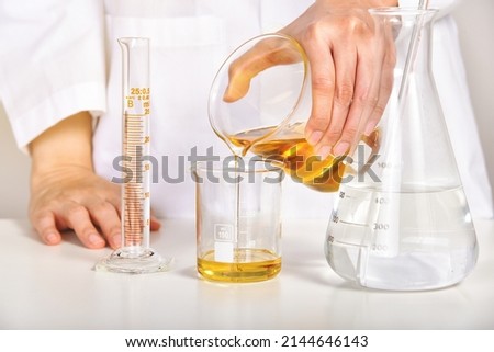 Oil pouring, Laboratory and science experiments, Formulating the chemical for medical research, Quality control of petroleum industry products concept. Royalty-Free Stock Photo #2144646143