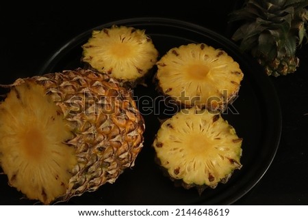 Closeup of cut Pineapple fruit with black background