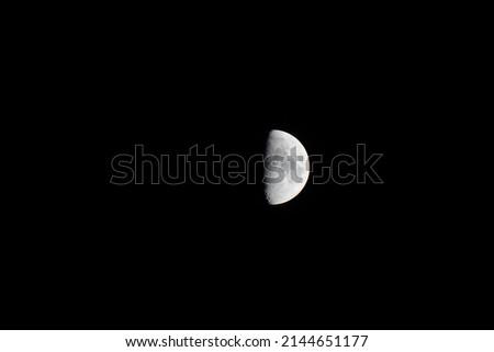 Half moon in the black night sky