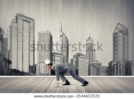 Young handsome businessman wearing white paper crown running in a hurry