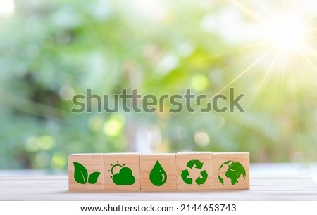 Plant save world concept. Net zero greenhouse gas emissions target. Climate neutral long term strategy. wooden cubes with green net zero icon and green icon on green nature background. Royalty-Free Stock Photo #2144653743