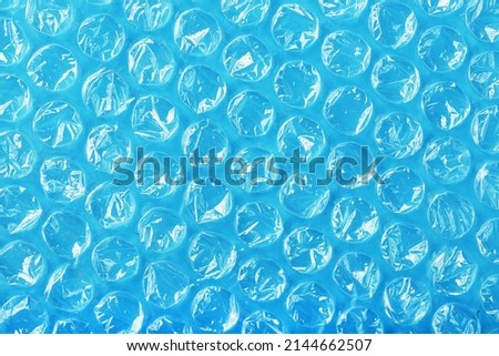 The texture of the packaging air-bubble film on a blue background in full screen