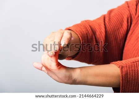 Close up hand of Asian woman she holding her acute pain in wrist of hands, studio shot isolated on white background, Healthcare medicine arthritis body care symptomatic office syndrome concept