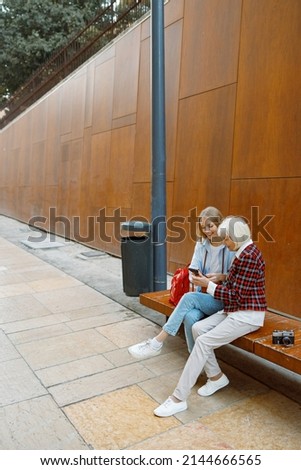 Two happy women relaxing in old city