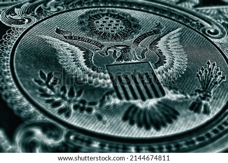 1 US dollar. Fragment of banknote. Reverse of bill with the Great Seal. The bald eagle is the national symbol. Dark blue-green inverted background. American treasury and treasuries. Economy of the USA Royalty-Free Stock Photo #2144674811