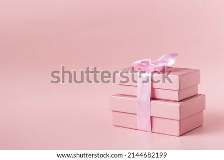 pink gift boxes on pink background, copy space