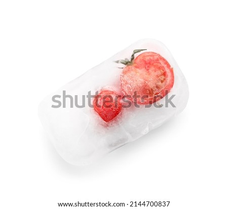 Fresh tomatoes frozen in ice on white background