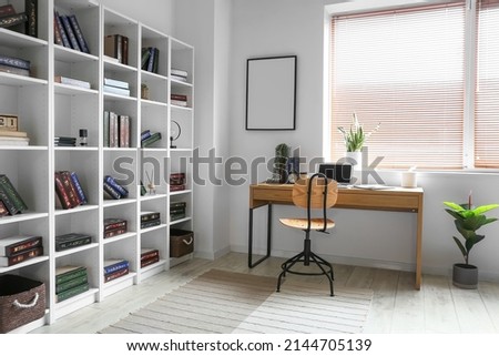 Interior of modern home library with workplace