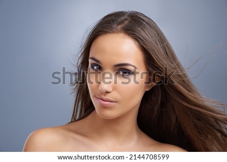 Taking haircare seriously. Studio head and shoulders shot of an attractive young model.