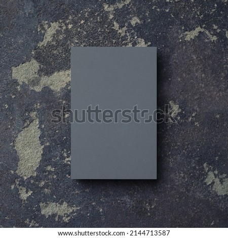 Photo of blank grey business card on concrete background. Branding mock up. Top view.