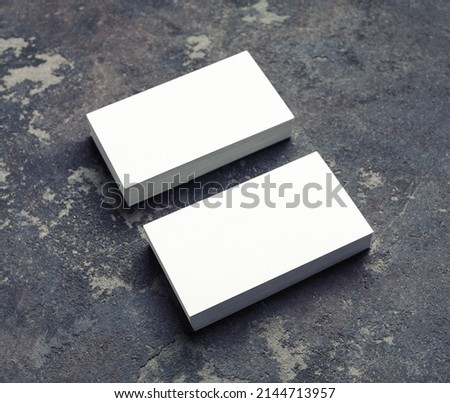 Photo of blank white business cards on concrete background. Template for ID. Mock up for for branding identity.